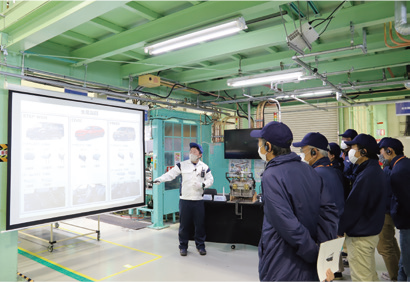 Individual investors listening to process explanation during plant tour